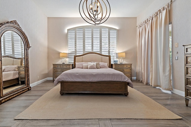 149 Sedona Way, Palm Beach Gardens, FL 33418 - bedroom featuring a chandelier, wood finished floors, and baseboards