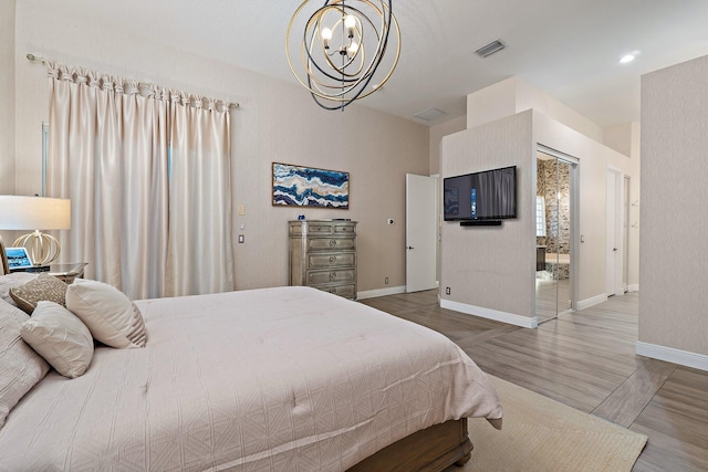 149 Sedona Way, Palm Beach Gardens, FL 33418 - bedroom with a chandelier, baseboards, and wood finished floors