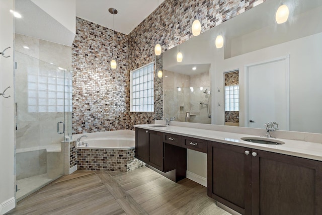 149 Sedona Way, Palm Beach Gardens, FL 33418 - bathroom featuring a garden tub, a stall shower, double vanity, tile walls, and wood finished floors