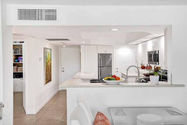 155 Isle Of Venice Dr Unit 304, Fort Lauderdale, FL 33301 - kitchen featuring appliances with stainless steel finishes, a sink, light countertops, white cabinetry, and recessed lighting