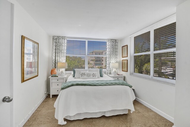 155 Isle Of Venice Dr Unit 304, Fort Lauderdale, FL 33301 - tiled bedroom featuring baseboards and multiple windows