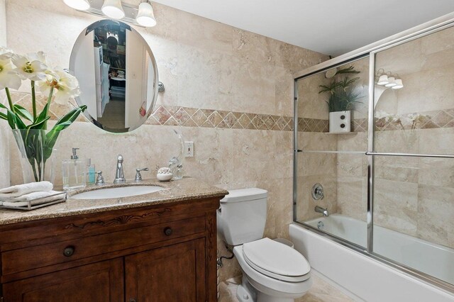 155 Isle Of Venice Dr Unit 304, Fort Lauderdale, FL 33301 - bathroom with tile walls, toilet, a stall shower, and vanity