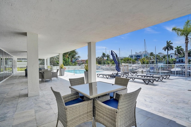 155 Isle Of Venice Dr Unit 304, Fort Lauderdale, FL 33301 - view of patio / terrace featuring outdoor dining space, fence, and a community pool
