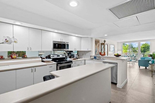 155 Isle Of Venice Dr Unit 304, Fort Lauderdale, FL 33301 - kitchen with stainless steel appliances, a sink, light countertops, a peninsula, and recessed lighting