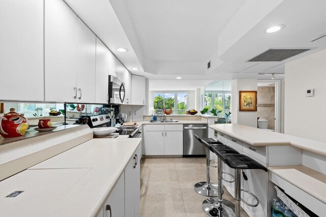 155 Isle Of Venice Dr Unit 304, Fort Lauderdale, FL 33301 - kitchen featuring stainless steel appliances, a sink, light tile patterned floors, light countertops, and recessed lighting