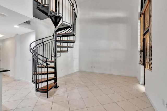 801 S Olive Ave Unit 127, West Palm Beach, FL 33401 - staircase featuring baseboards, visible vents, and tile patterned flooring