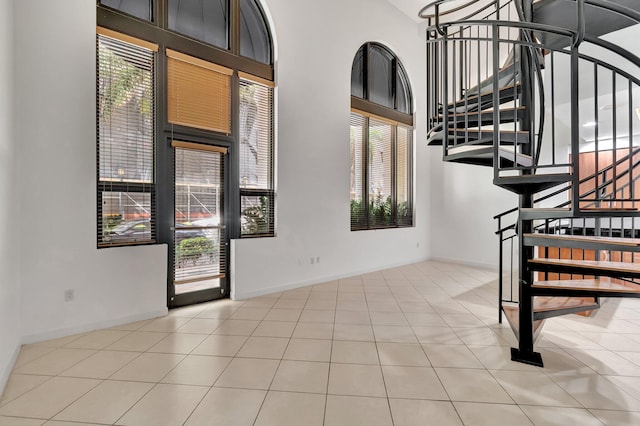 801 S Olive Ave Unit 127, West Palm Beach, FL 33401 - entryway with a high ceiling, baseboards, a healthy amount of sunlight, and stairs