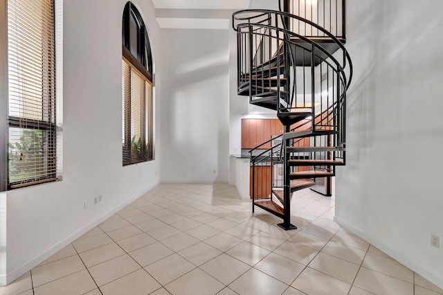 801 S Olive Ave Unit 127, West Palm Beach, FL 33401 - stairway with a towering ceiling, tile patterned floors, and a healthy amount of sunlight
