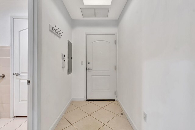 801 S Olive Ave Unit 127, West Palm Beach, FL 33401 - hallway featuring light tile patterned floors, electric panel, and baseboards