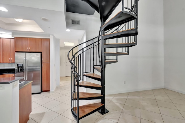 801 S Olive Ave Unit 127, West Palm Beach, FL 33401 - stairway featuring tile patterned floors, visible vents, a raised ceiling, and baseboards