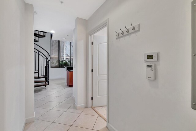 801 S Olive Ave Unit 127, West Palm Beach, FL 33401 - hallway featuring baseboards, stairway, and light tile patterned floors