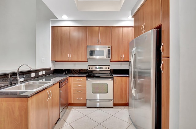 801 S Olive Ave Unit 127, West Palm Beach, FL 33401 - kitchen with light tile patterned floors, a peninsula, appliances with stainless steel finishes, and a sink