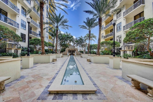 801 S Olive Ave Unit 127, West Palm Beach, FL 33401 - view of pool with a patio and exterior fireplace