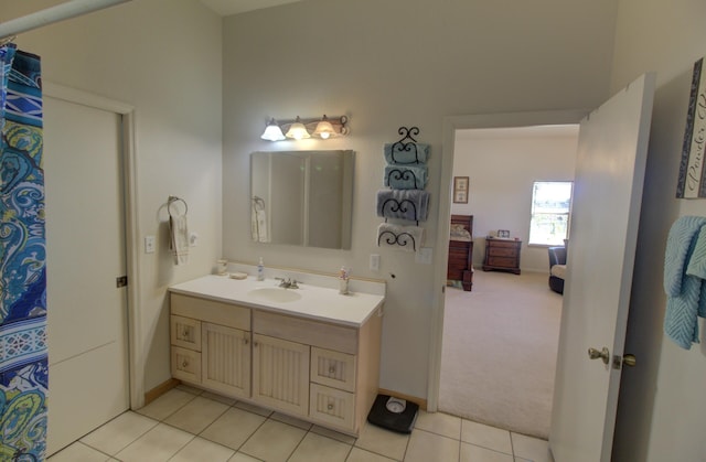 full bathroom featuring baseboards, tile patterned flooring, and vanity