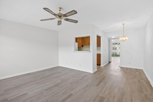 63 Dorset Unit B, Boca Raton, FL 33434 - empty room with a chandelier, wood finished floors, and a ceiling fan