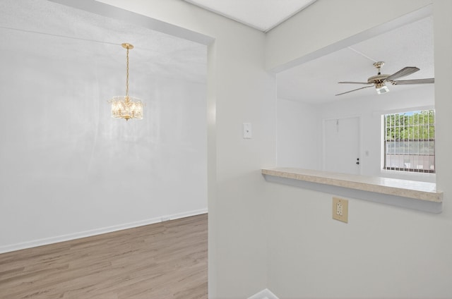 63 Dorset Unit B, Boca Raton, FL 33434 - kitchen featuring wood finished floors, ceiling fan, a chandelier, and hanging light fixtures