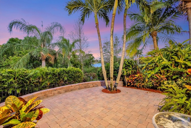 view of patio / terrace featuring driveway and a water view