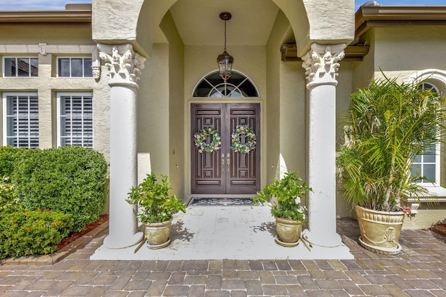 property entrance with stucco siding