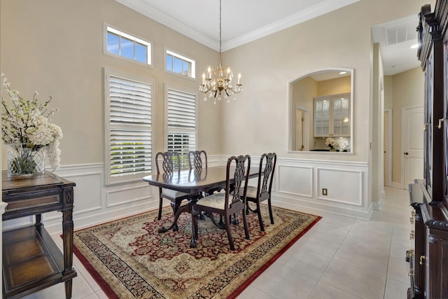 dining area with arched walkways, a wealth of natural light, and light tile patterned floors
