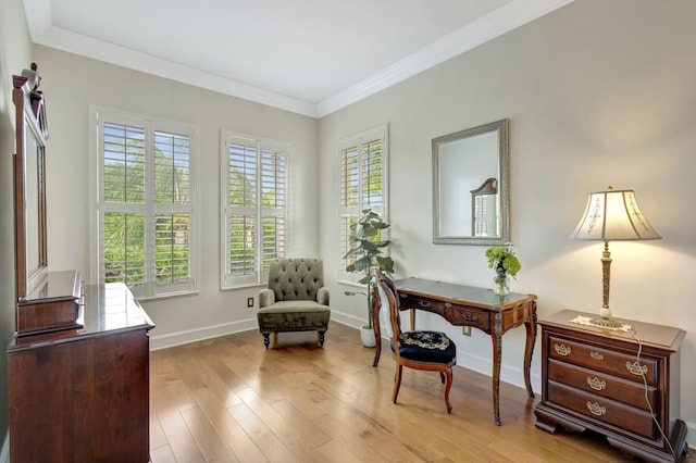 sitting room featuring baseboards, ornamental molding, and wood finished floors
