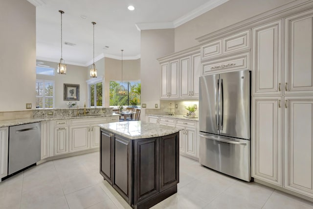 kitchen featuring light tile patterned floors, crown molding, a sink, and stainless steel appliances