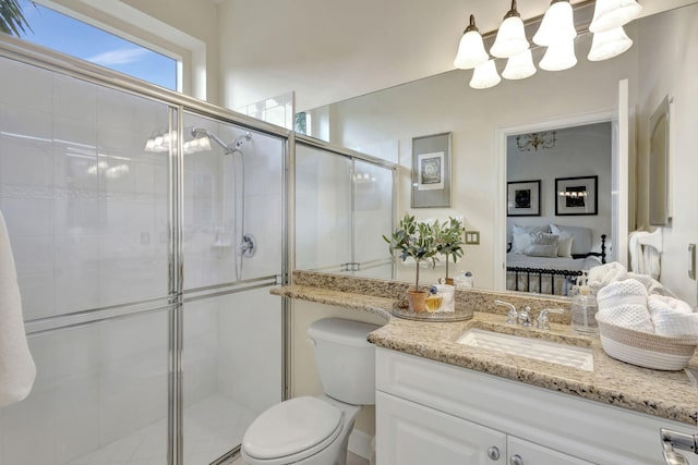 ensuite bathroom featuring a stall shower, toilet, vanity, and ensuite bath