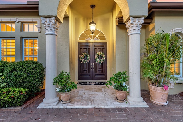 view of exterior entry with stucco siding