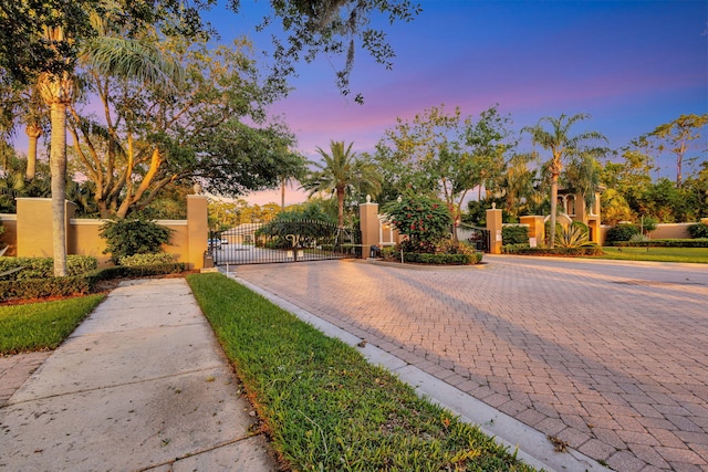 view of front of property featuring a gate, stucco siding, and fence