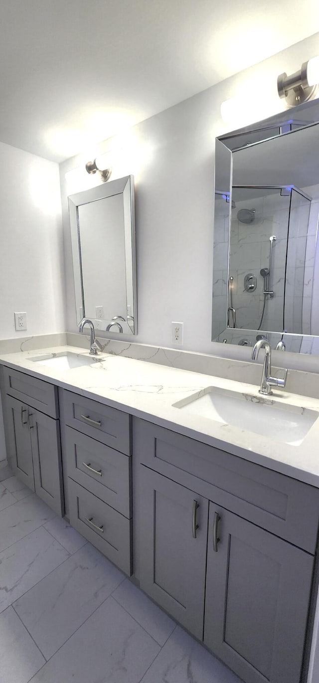 211 2nd Ct, Palm Beach Gardens, FL 33410 - bathroom featuring marble look tiles, double vanity, and a shower