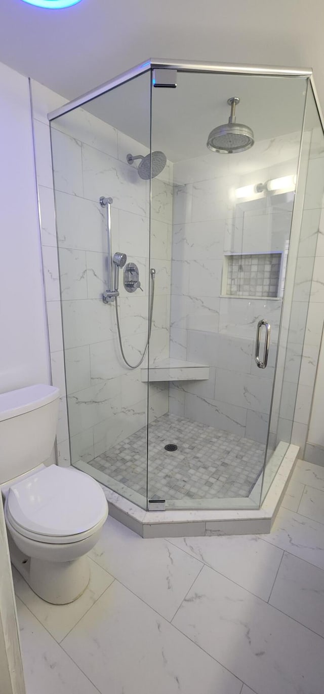 211 2nd Ct, Palm Beach Gardens, FL 33410 - bathroom featuring marble finish flooring, a stall shower, and toilet