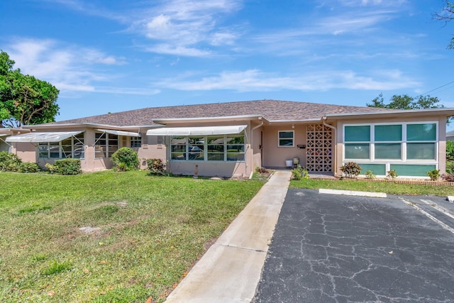 1245 High Point Pl S Unit C, Delray Beach, FL 33445 - ranch-style house with a front lawn, uncovered parking, and stucco siding