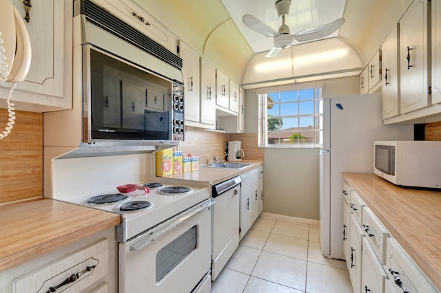 1245 High Point Pl S Unit C, Delray Beach, FL 33445 - kitchen with a ceiling fan, tasteful backsplash, a sink, light tile patterned floors, and white appliances