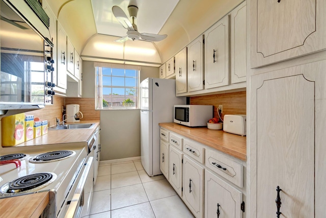 1245 High Point Pl S Unit C, Delray Beach, FL 33445 - kitchen with ceiling fan, tasteful backsplash, a sink, white appliances, and light tile patterned flooring
