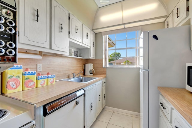 1245 High Point Pl S Unit C, Delray Beach, FL 33445 - kitchen with light tile patterned flooring, a sink, white appliances, light countertops, and decorative backsplash