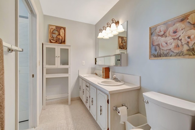 1245 High Point Pl S Unit C, Delray Beach, FL 33445 - bathroom with double vanity, toilet, a sink, and a closet