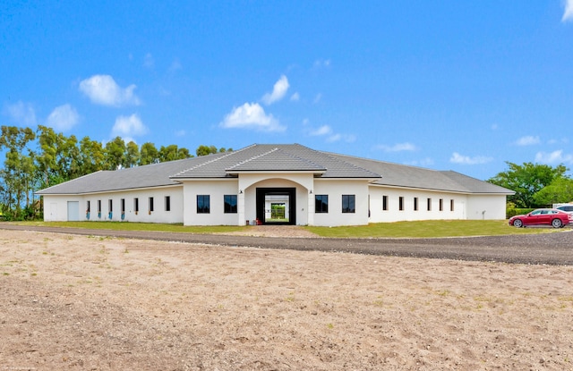TBD 125th Ave S, Wellington, FL 33414 - view of front of home with stucco siding, a tiled roof, and a front yard