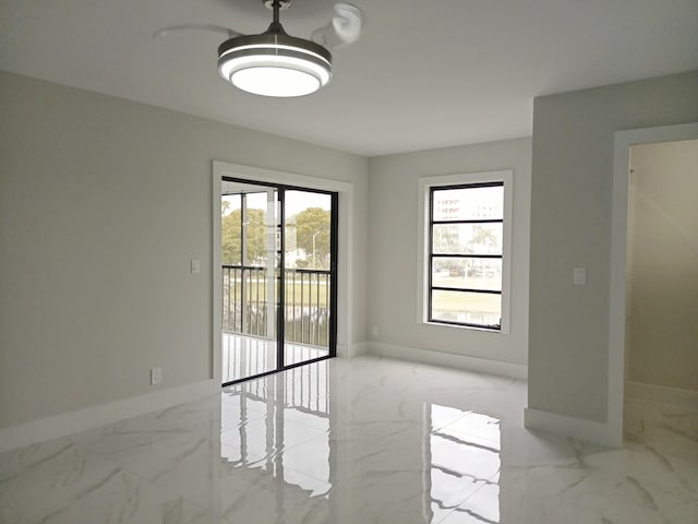 empty room with baseboards and marble finish floor