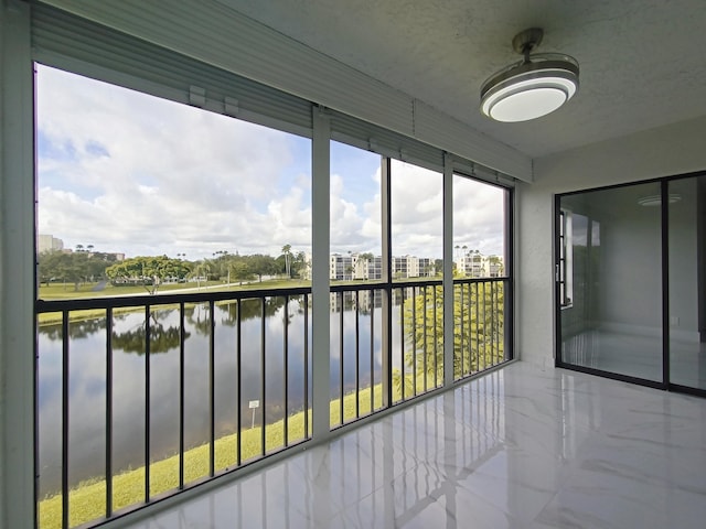 unfurnished sunroom with a water view