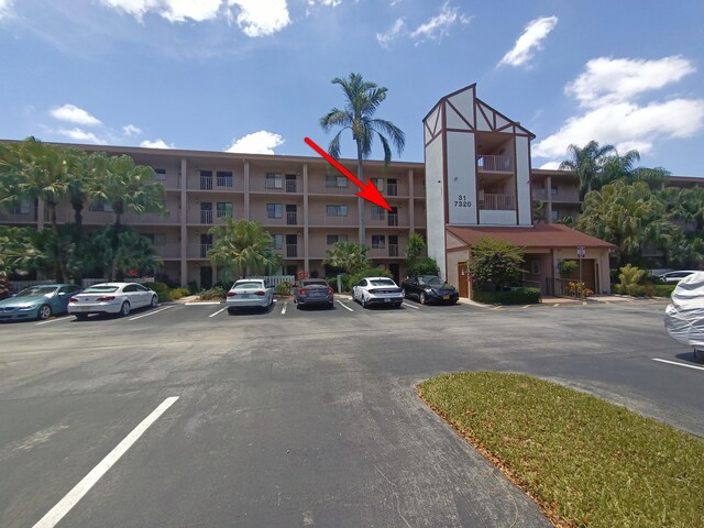 7320 Amberly Ln Unit 305, Delray Beach, FL 33446 - view of apartment building / complex with uncovered parking