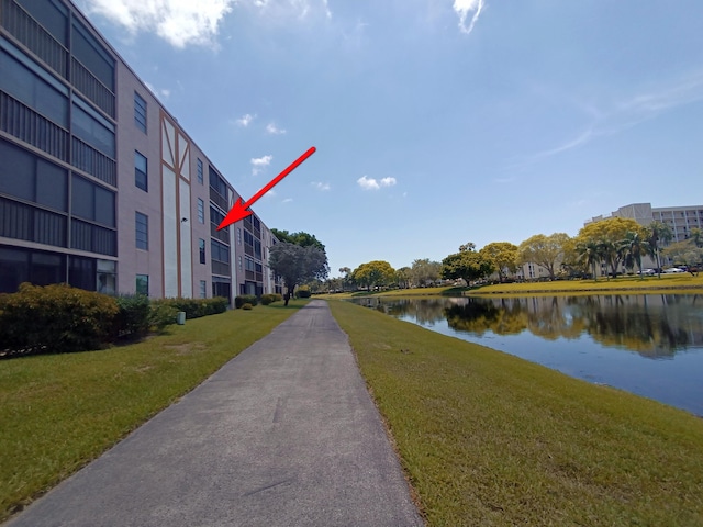 7320 Amberly Ln Unit 305, Delray Beach, FL 33446 - view of property's community with a lawn and a water view