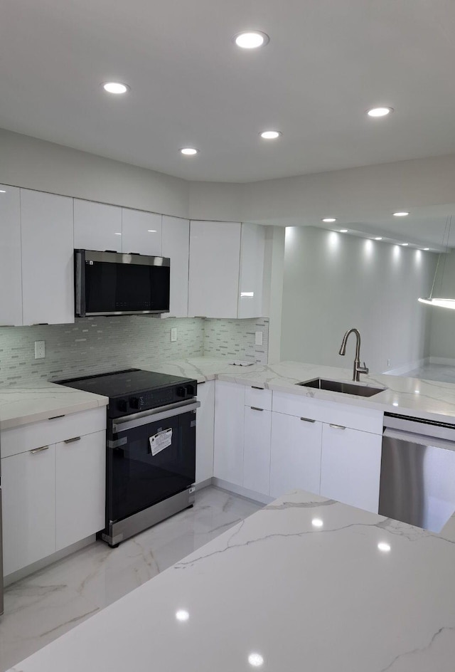 7320 Amberly Ln Unit 305, Delray Beach, FL 33446 - kitchen with appliances with stainless steel finishes, a sink, modern cabinets, white cabinets, and recessed lighting