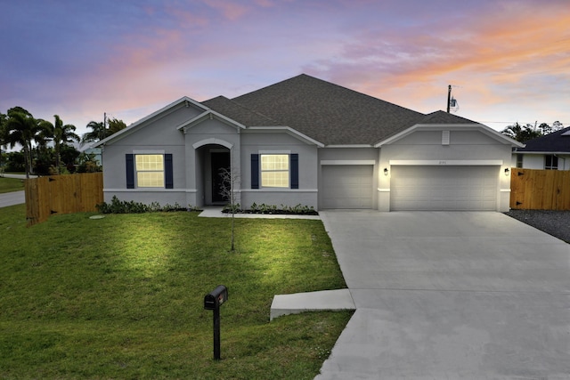 single story home featuring stucco siding, a garage, fence, and concrete driveway