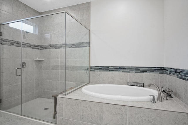 full bathroom featuring a stall shower and a bath
