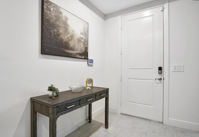 interior space with light tile patterned flooring and baseboards