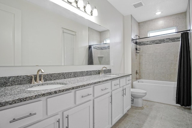 full bath featuring shower / tub combo with curtain, visible vents, a sink, and toilet