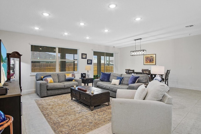 living room with light tile patterned flooring, baseboards, visible vents, and recessed lighting