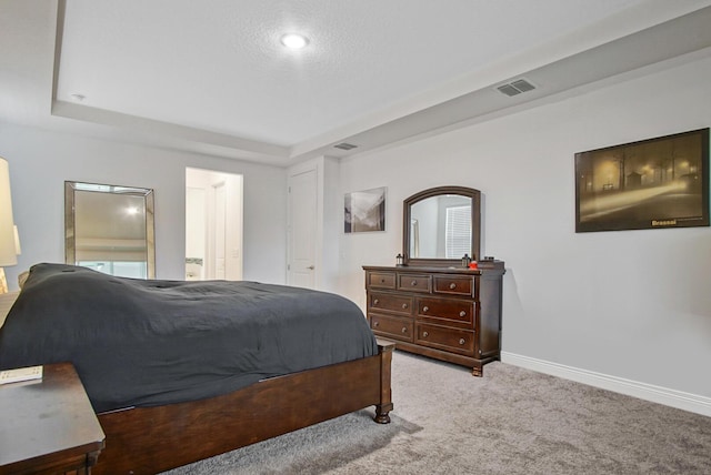 bedroom featuring carpet flooring, a raised ceiling, baseboards, and visible vents