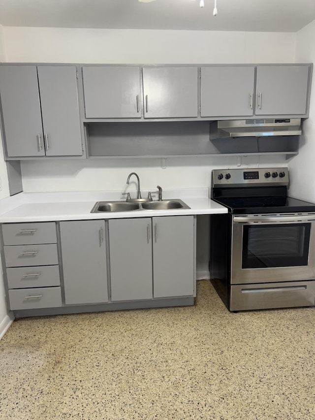 7507 Arthurs Rd, Fort Pierce, FL 34951 - kitchen with stainless steel electric range oven, under cabinet range hood, light countertops, a sink, and gray cabinetry