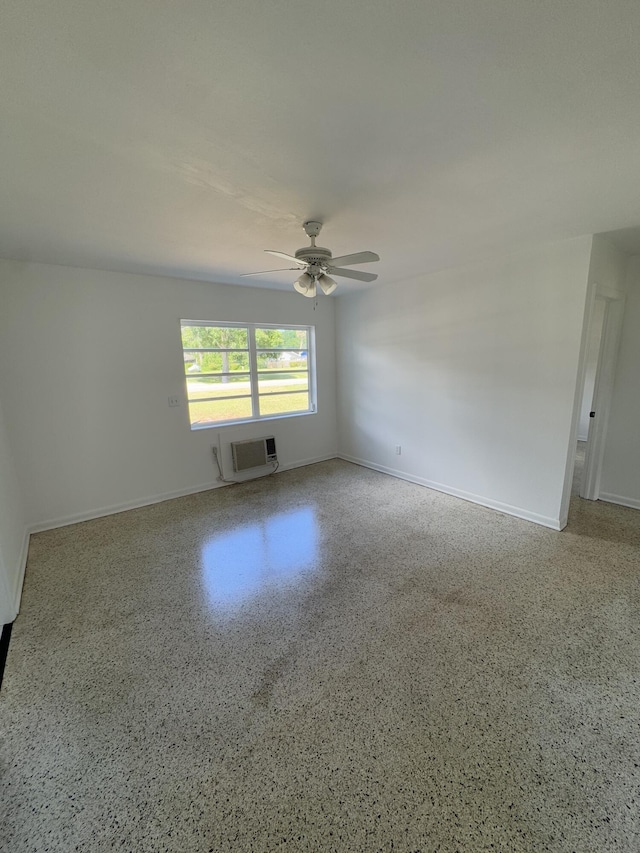 7507 Arthurs Rd, Fort Pierce, FL 34951 - unfurnished room featuring baseboards, an AC wall unit, speckled floor, and ceiling fan