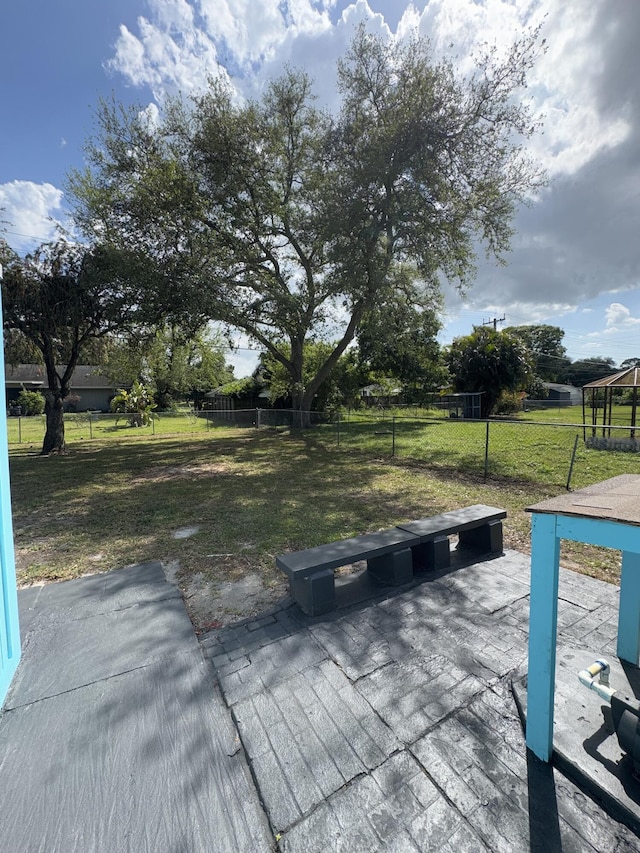7507 Arthurs Rd, Fort Pierce, FL 34951 - wooden deck with a patio, a yard, and fence